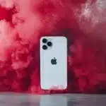 a white cell phone with red smoke